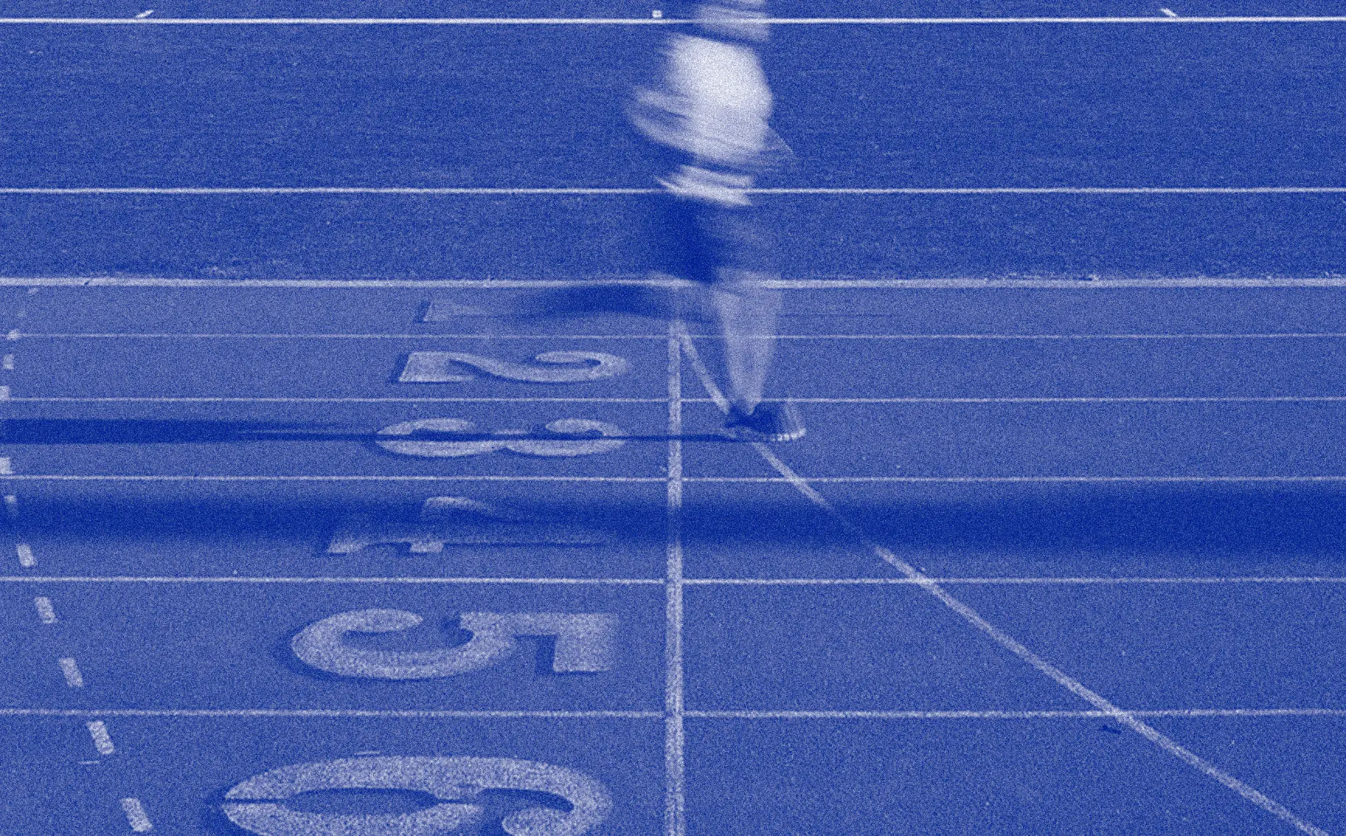 Blue-toned running track with lane numbers
